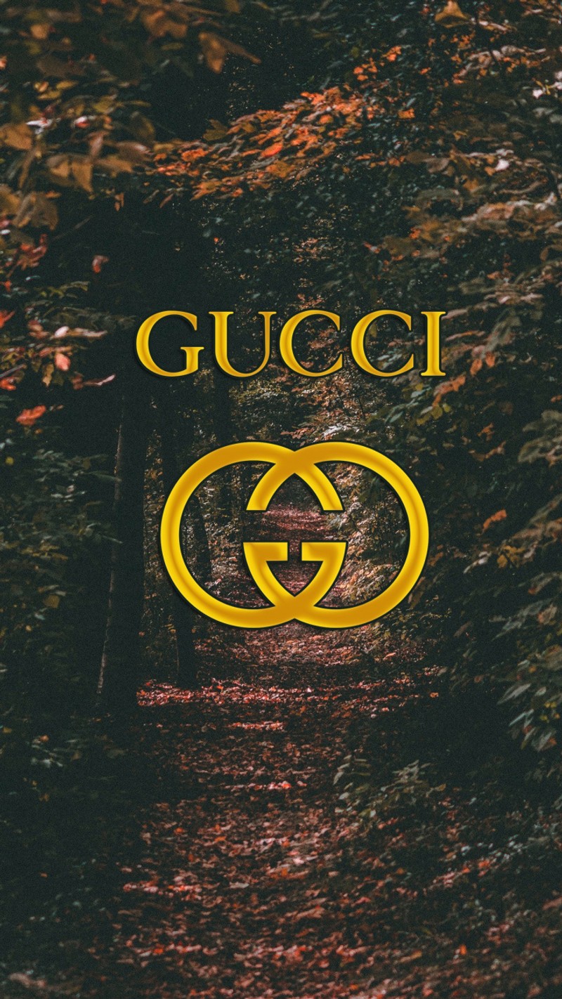 A close up of a sign on a path in the woods (brand, colors, gucci, logos, nature)