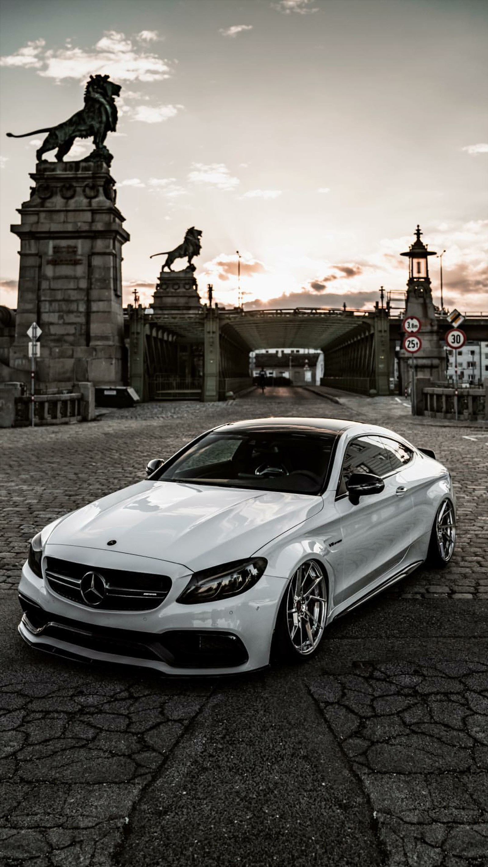 Arafed mercedes coupe parked in front of a statue in a city (mercedes, amg, white, car, supercar)