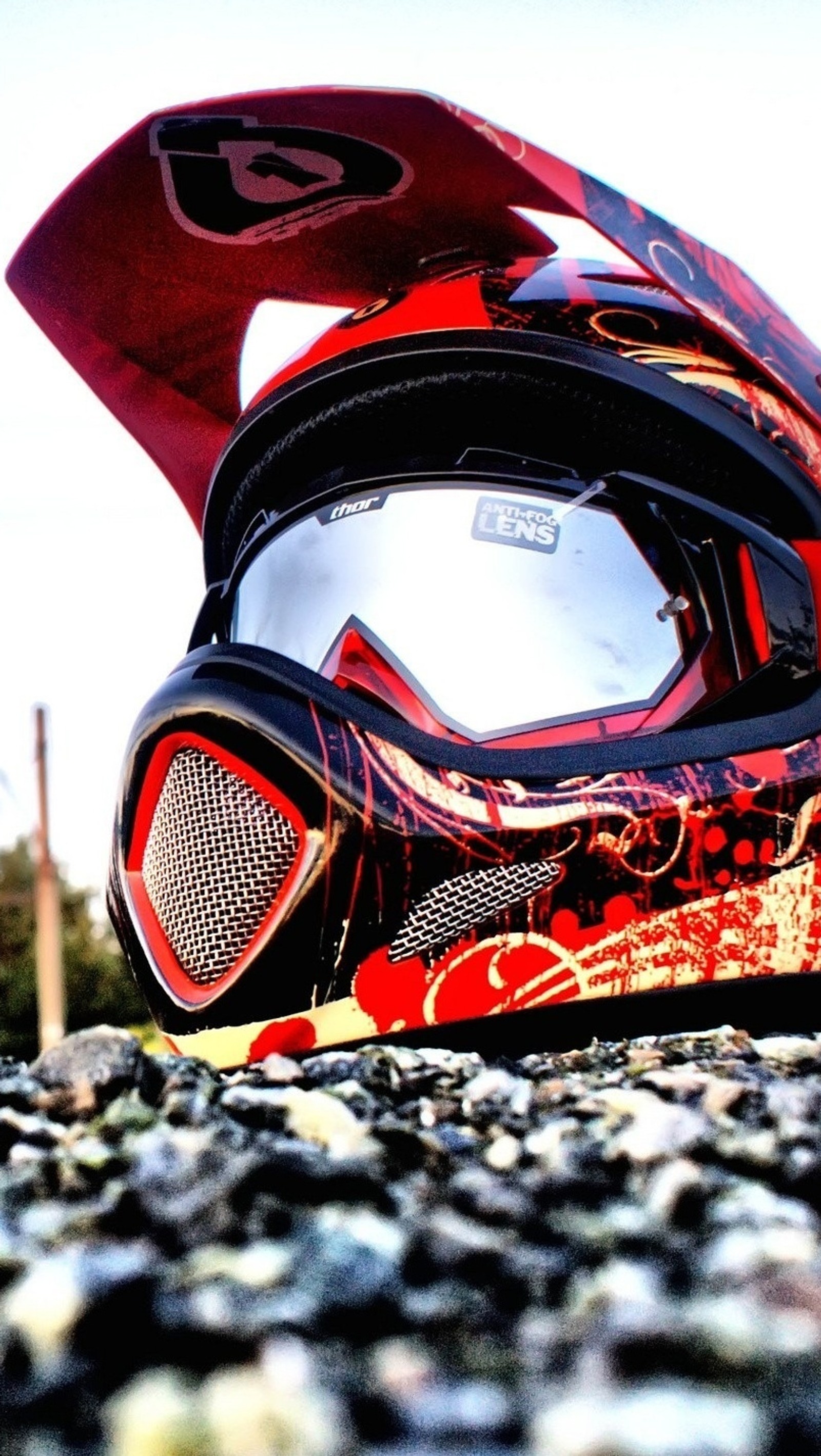 A close up of a helmet with a red and black design on it (extreme, helmet, motorcycle, red)