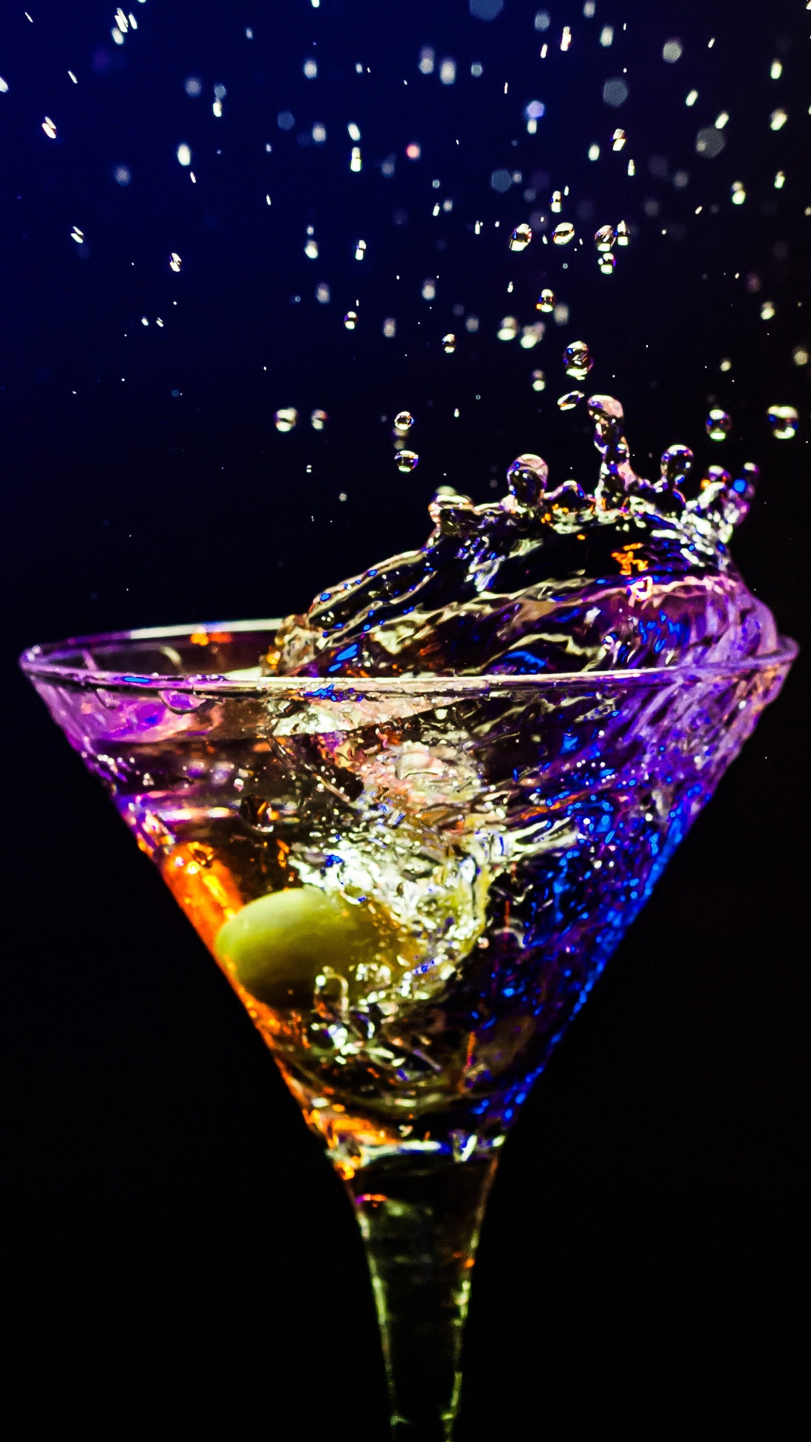 Arafly shot of a martini glass with a splash of water and olives (2016, cocktail)