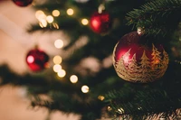 Decorative Red Christmas Ornament on a Tree with Twinkling Lights