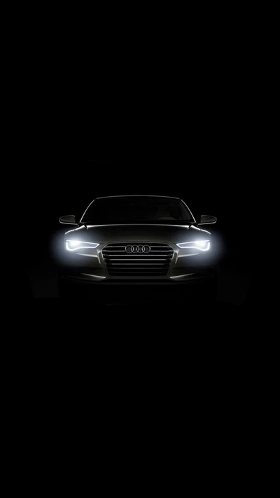 Audi noir élégant : avant de voiture illuminé sur fond sombre