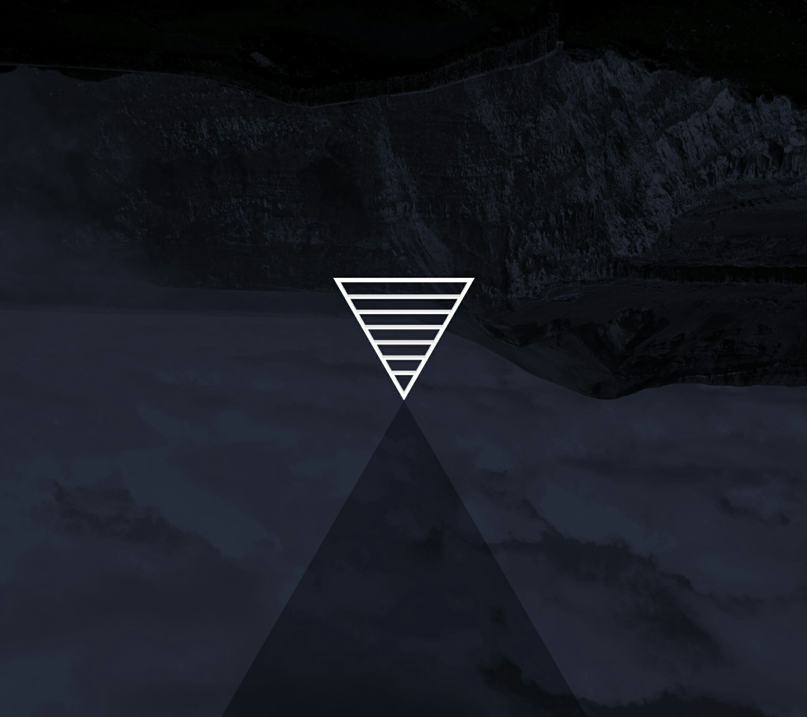 A close up of a triangle with a mountain in the background (black, shade, stripes, triangle, white)