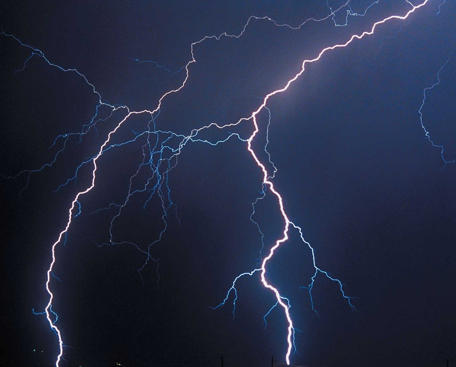 Lightning strikes across the sky over a city at night (colorado, fort collins, lightning storm)