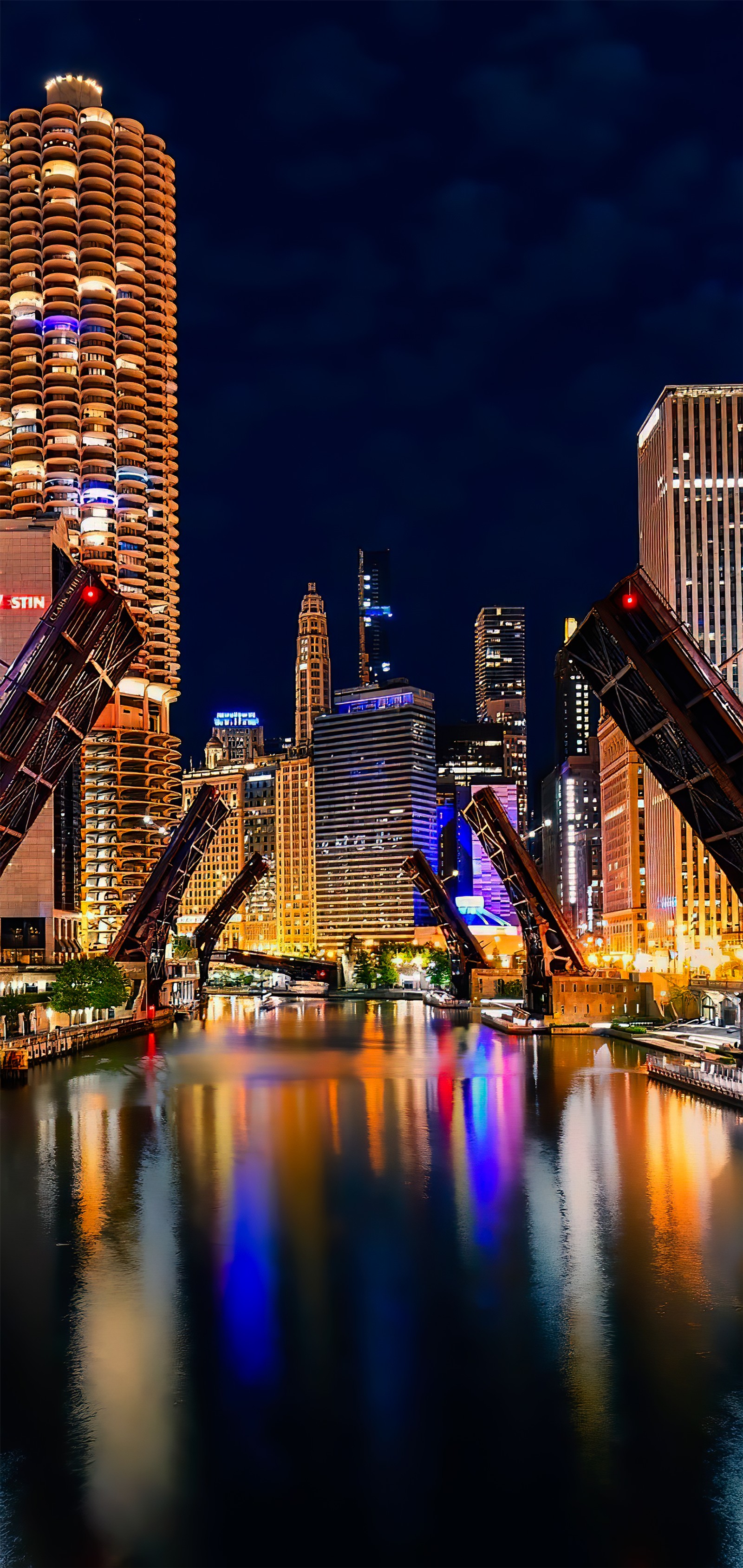 Arafed bridge over a river with a city in the background (skyscraper, chicago, building, water, light)