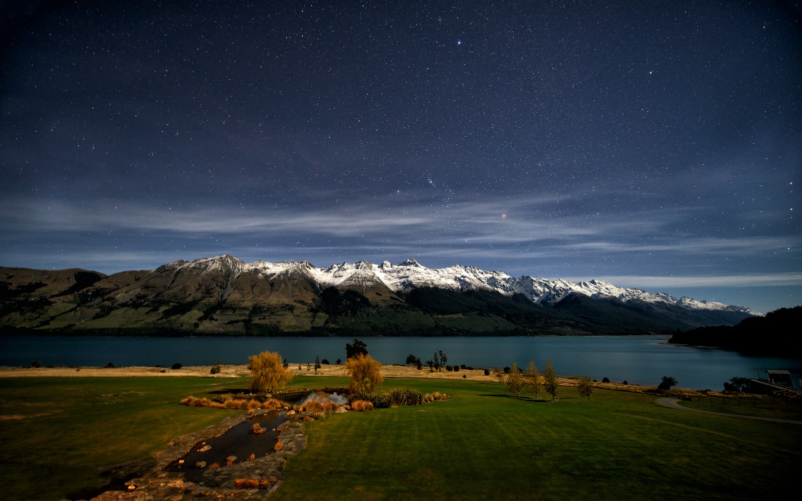 A view of a lake and mountains with a sky full of stars (nature, highland, night, lake, atmosphere)