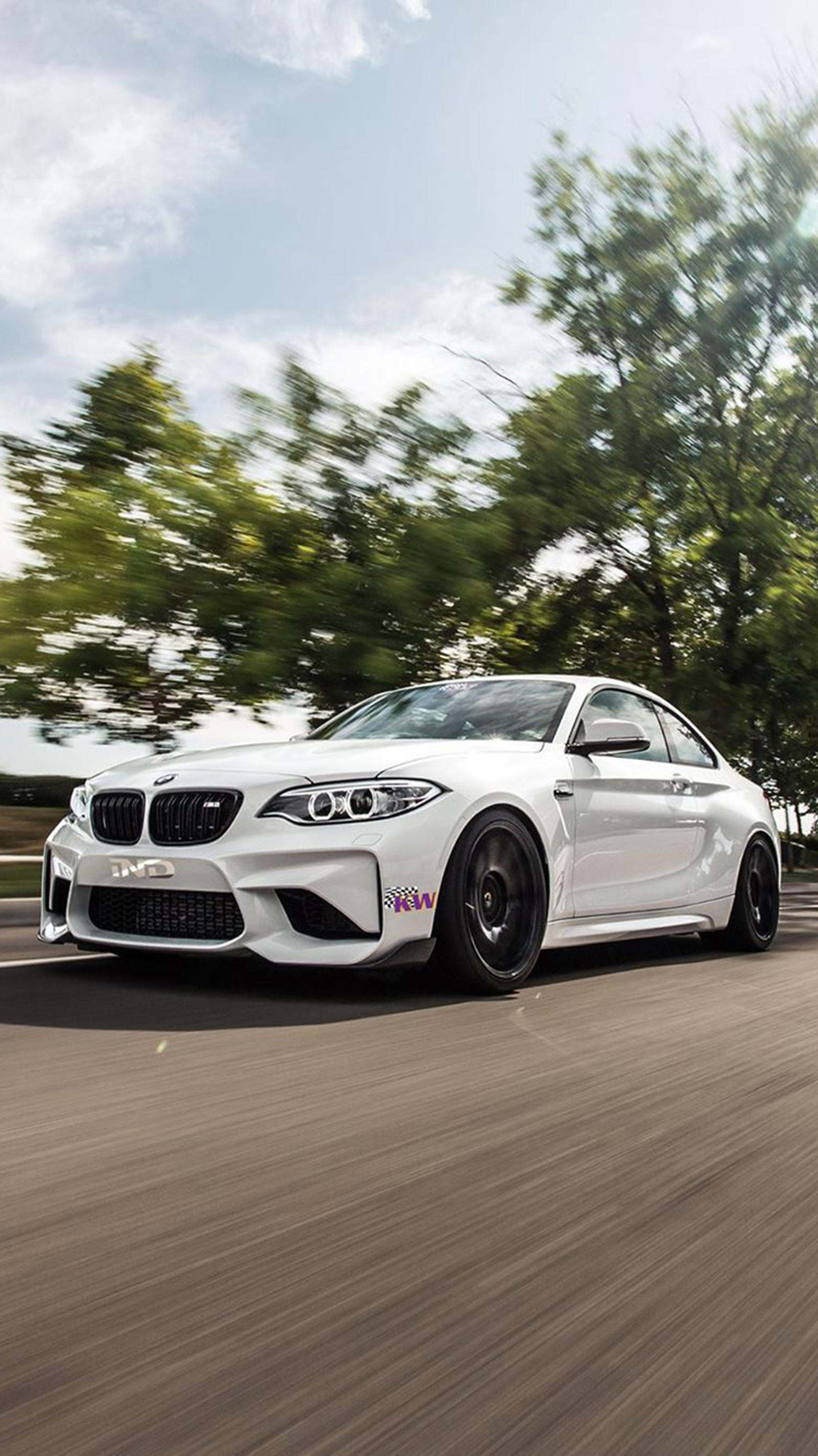 A close up of a white bmw car driving on a road (bmw, car, coupe, ind, m2)