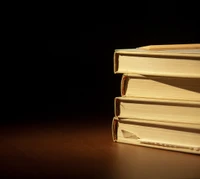 Stacked Books in a Dimly Lit Library