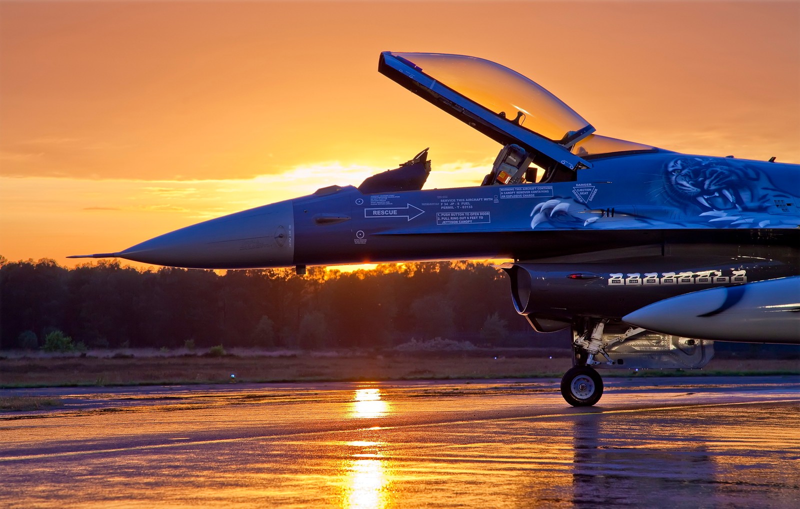 Arafed jet sitting on tarmac with open door at sunset (military aircraft, aircraft, airplane, jet aircraft, aviation)