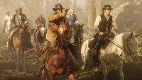 A group of cowboys on horseback navigates a misty forest path, embodying the adventurous spirit of the American frontier in "Red Dead Redemption 2.