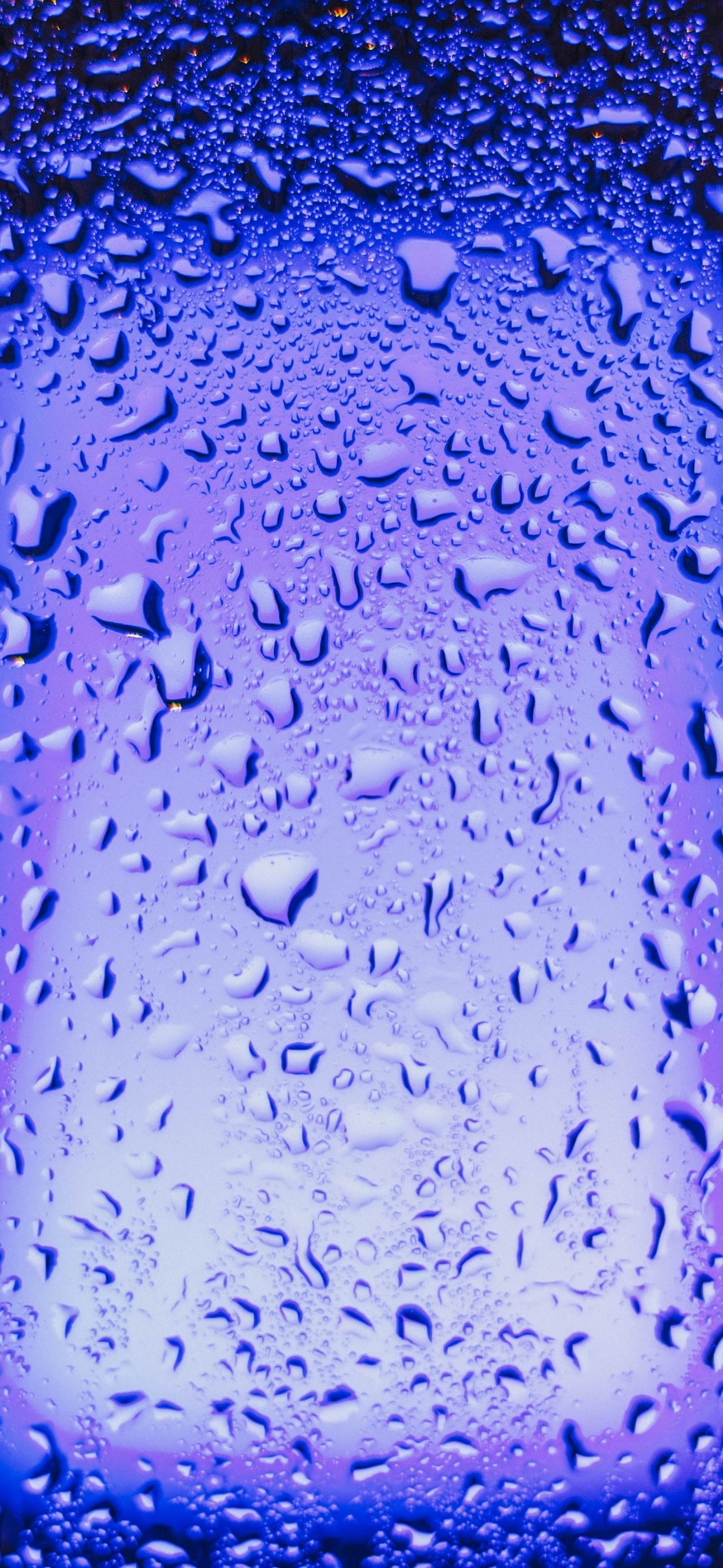 A close up of a blue glass with water droplets on it (glass, neon lighting, water, liquid, blue)