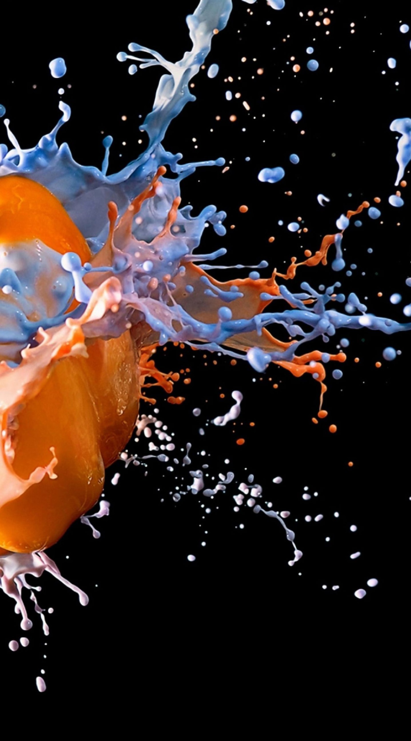 There is a orange being splashed with blue and orange liquid (paint, water, liquid, drink, drop)