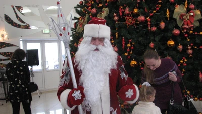 Santa Claus with a child near a beautifully decorated Christmas tree, surrounded by holiday cheer and festive decorations.