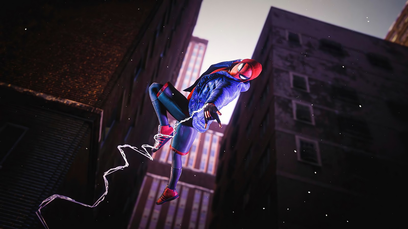 Spider-man en un costume est suspendu à un bâtiment (marvels spider man miles morales, playstation 5, ps5, ps4, jeu vidéo)