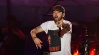 Eminem delivers an electrifying performance on stage, engaging the audience with dynamic energy and powerful expression.