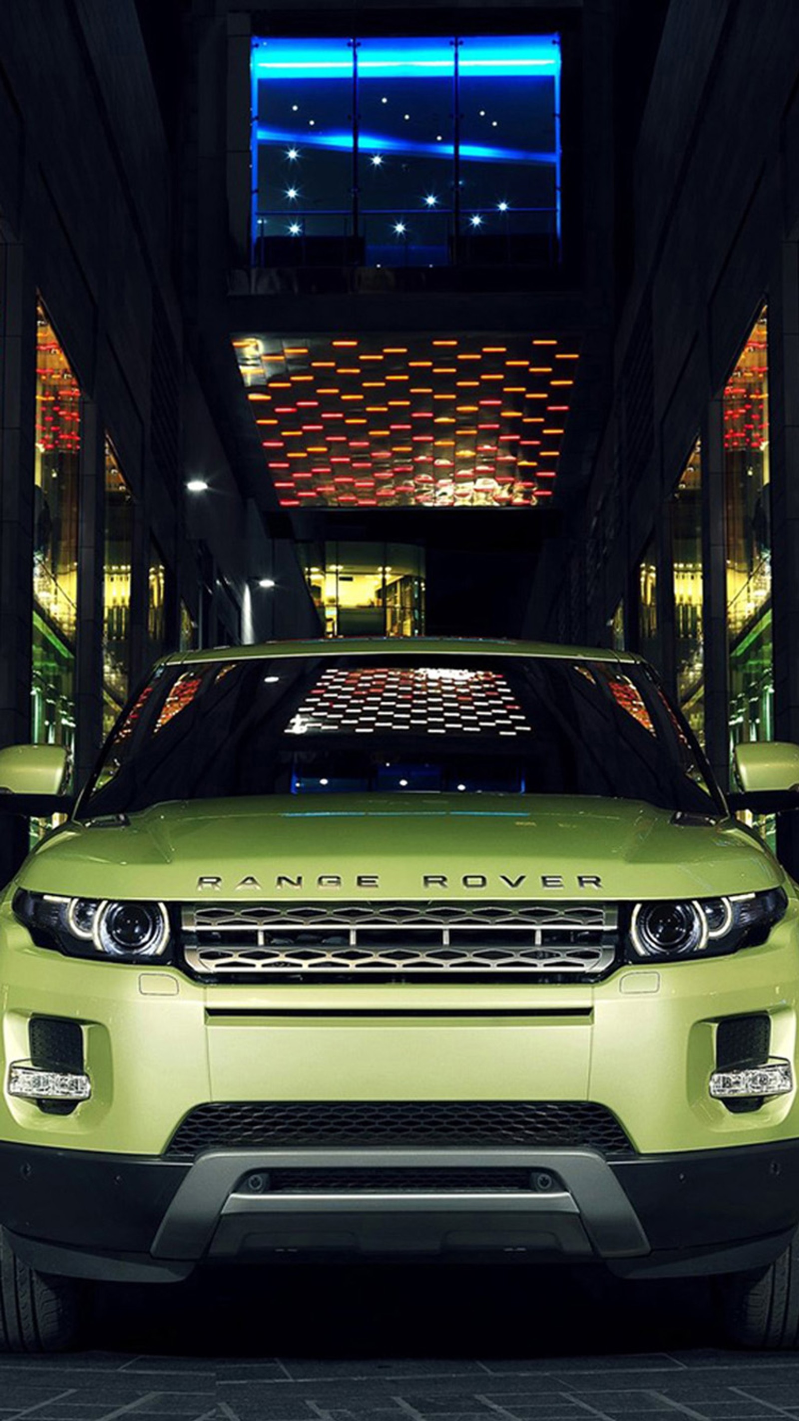 A close up of a green land rover parked in a parking garage (envoque, green, range, rover)