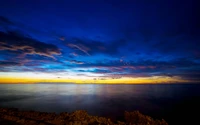 Tranquil Dusk Over the Australian Horizon: A Serene Sea and Colorful Afterglow