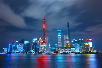 Horizonte iluminado de Xangai com a Torre da Pérola Oriental e o Bund à noite