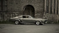 Classic Ford Shelby Mustang in a vintage industrial setting.