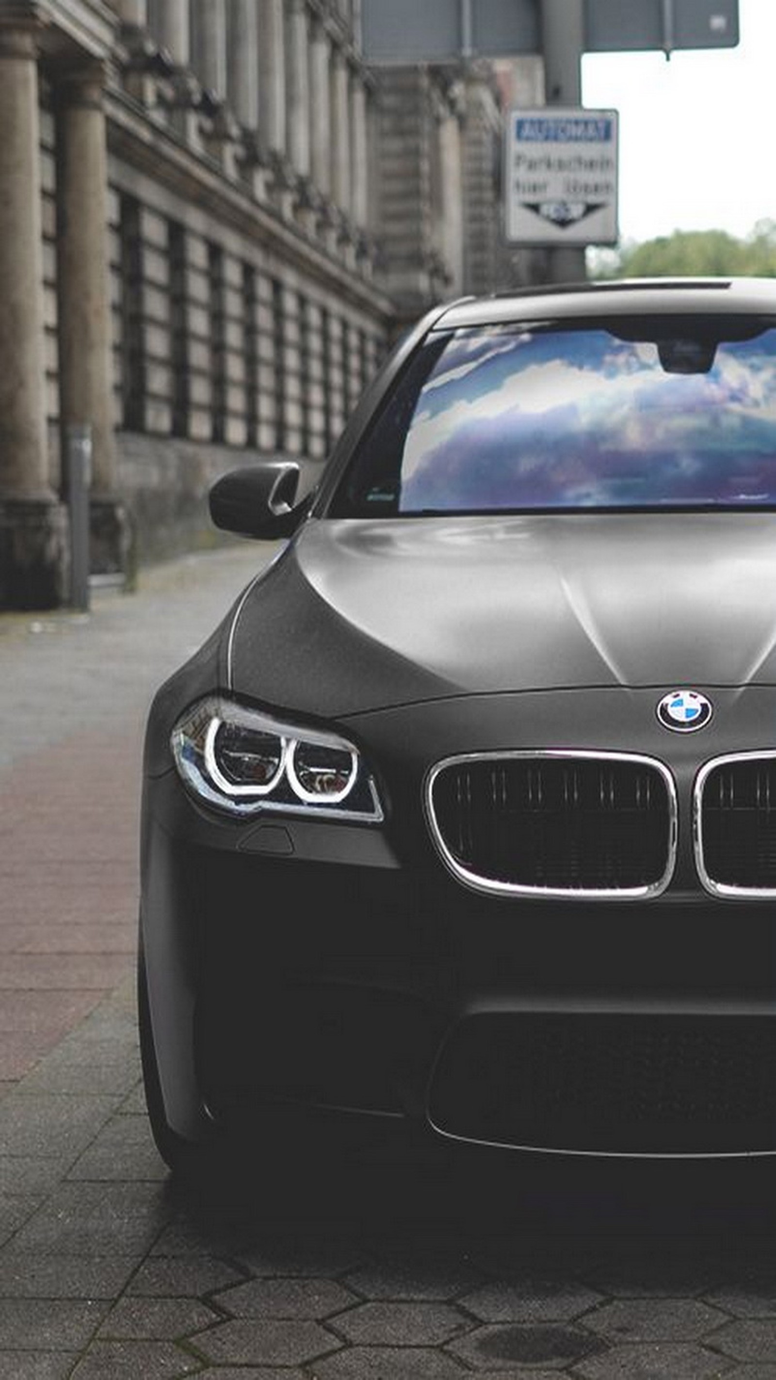 Arafed black bmw car parked on a city street (bmw, bmw m5)