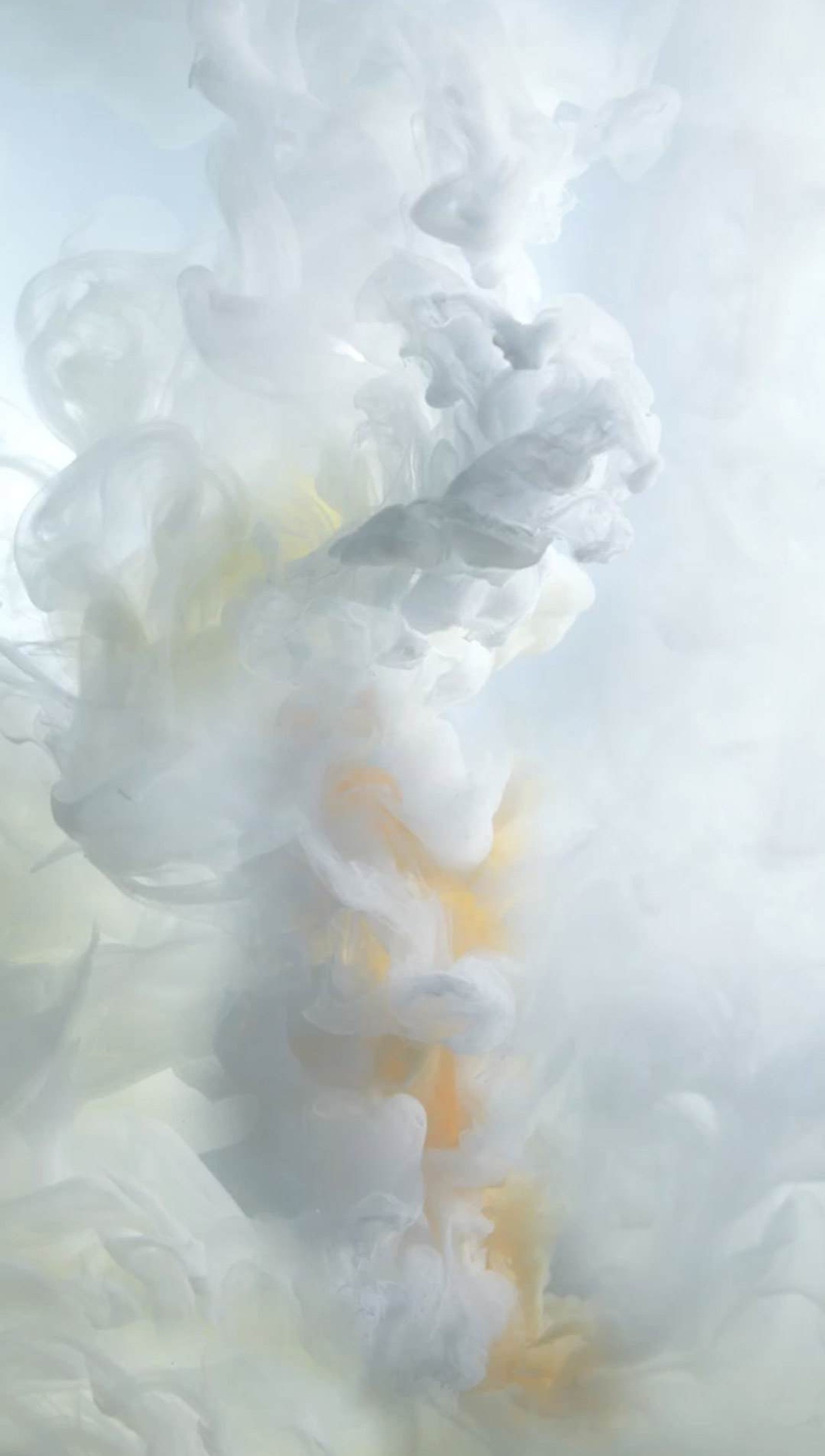 There is a white cloud of smoke rising from a black vase (apple, iphone)