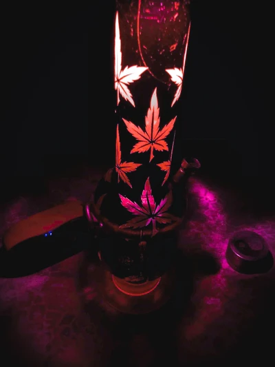 Illuminated Bong with Leaf Patterns and Vibrant Lighting