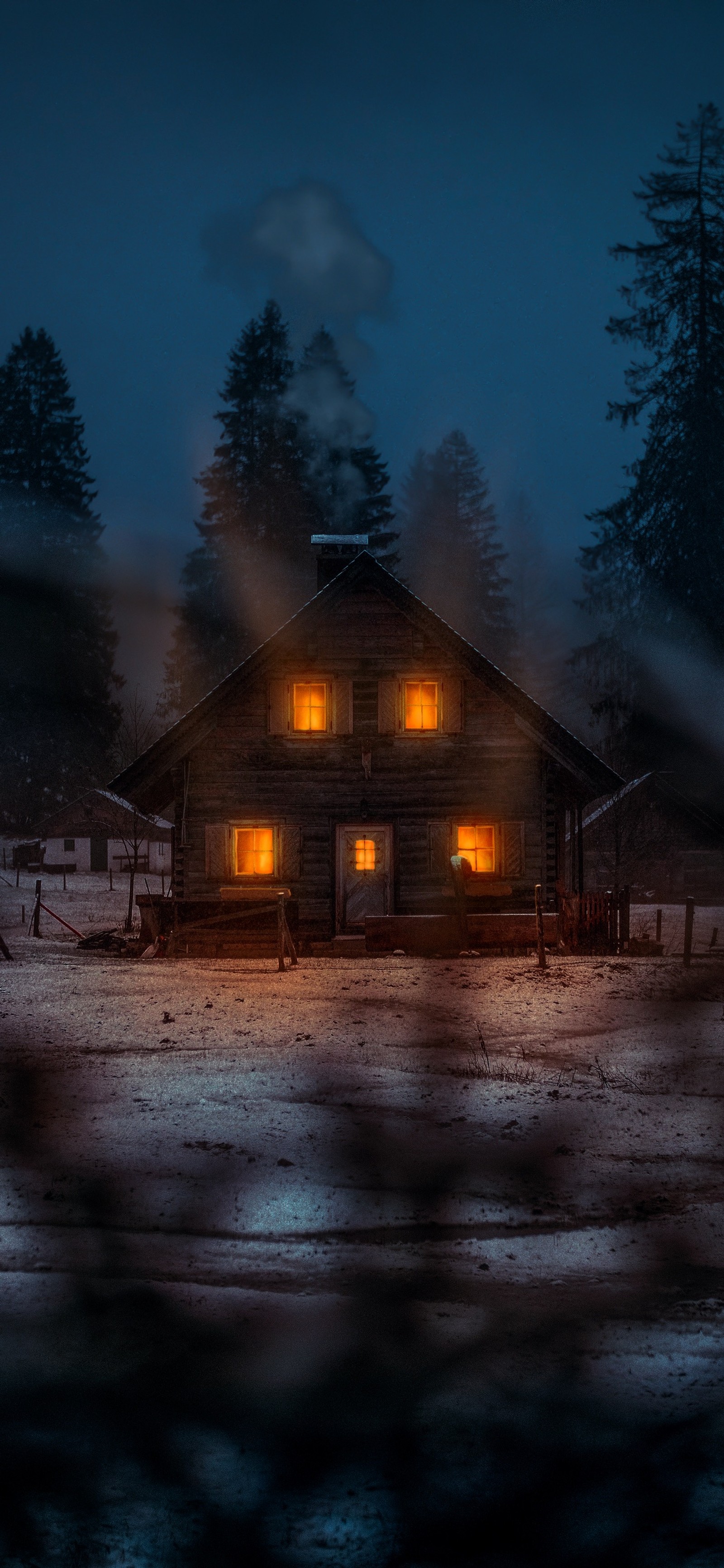 Nighttime scene of a cabin in the woods with a light on (atmosphere, snow, tree, house, landscape)