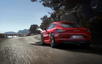 2014 Porsche Cayman S on a winding road, showcasing its sleek design and performance.