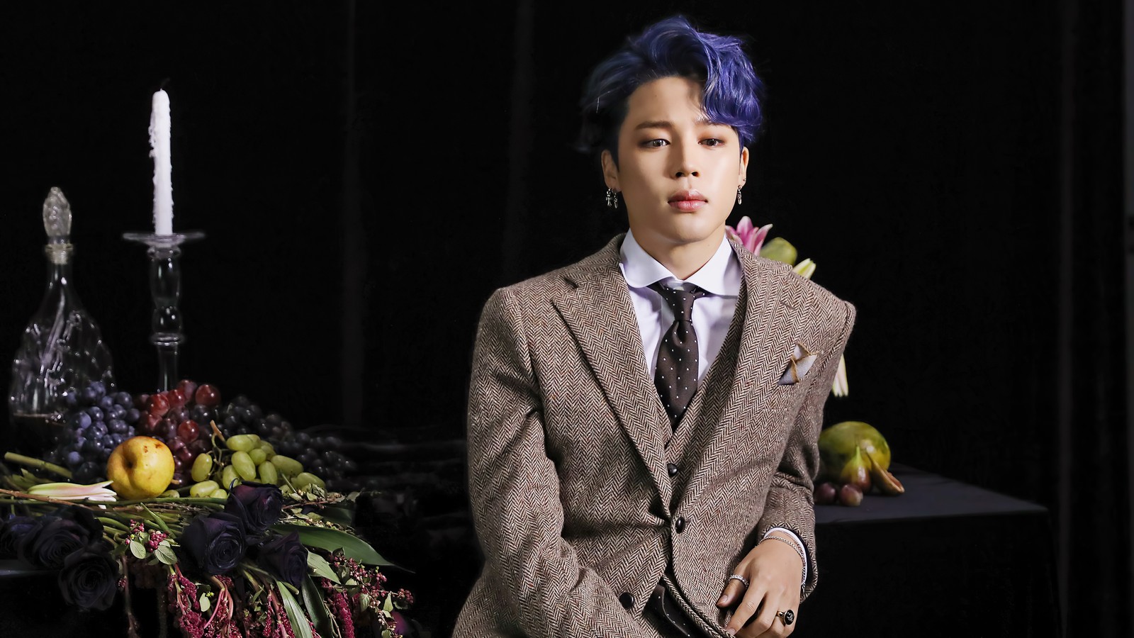 Arafed male in a suit and tie sitting in front of a table with fruit (jimin, 지민, park ji min, 박지민, bangtan boys)