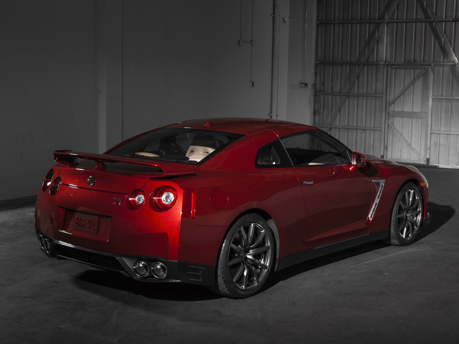 A close up of a red sports car in a garage (2014 nissan gt r, sports car, nissan, car, supercar)