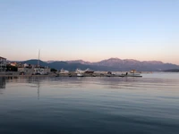 Tranquil Reflections of a Mountainous Horizon at Dusk