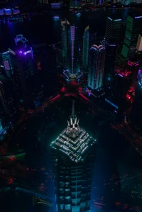 Vibrant Night Skyline of Shanghai: Aerial View of Skyscrapers Illuminated by City Lights