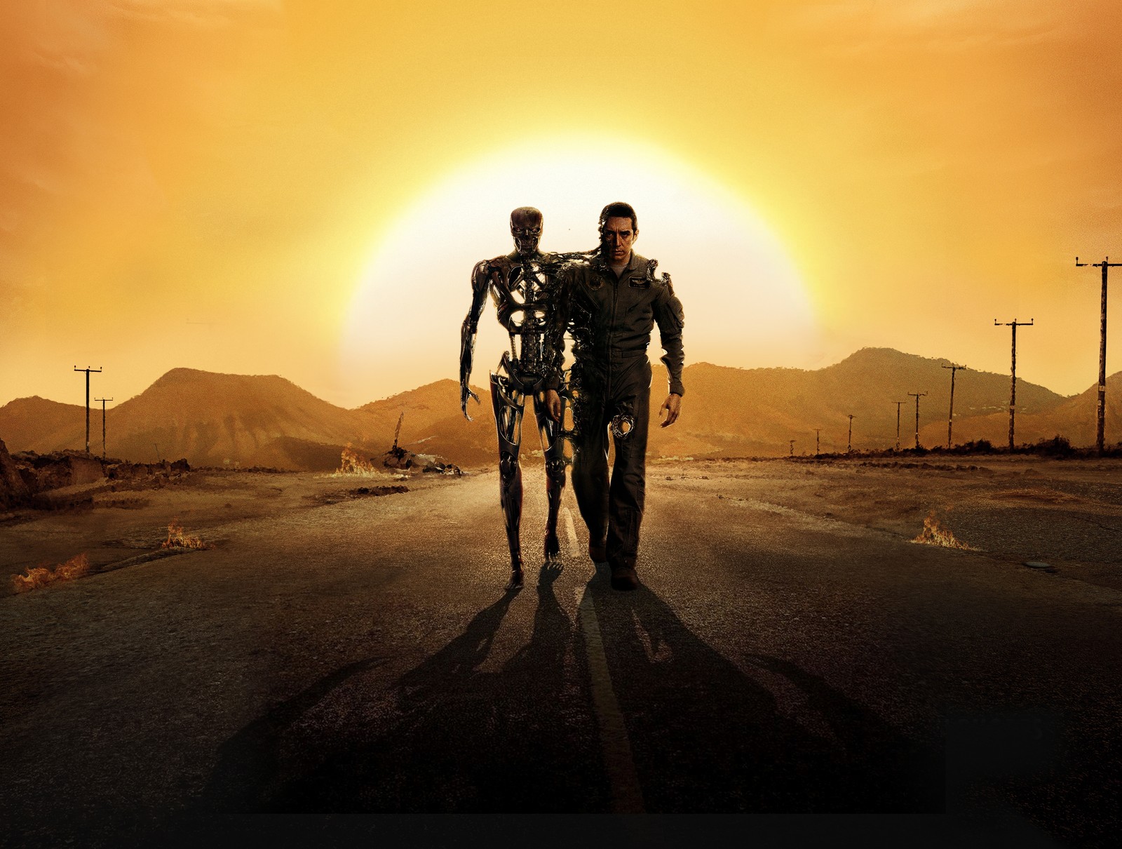 Vista aérea de dos hombres caminando por un camino con un atardecer de fondo (sarah connor, paramount pictures, el exterminador, the terminator, amarillo)