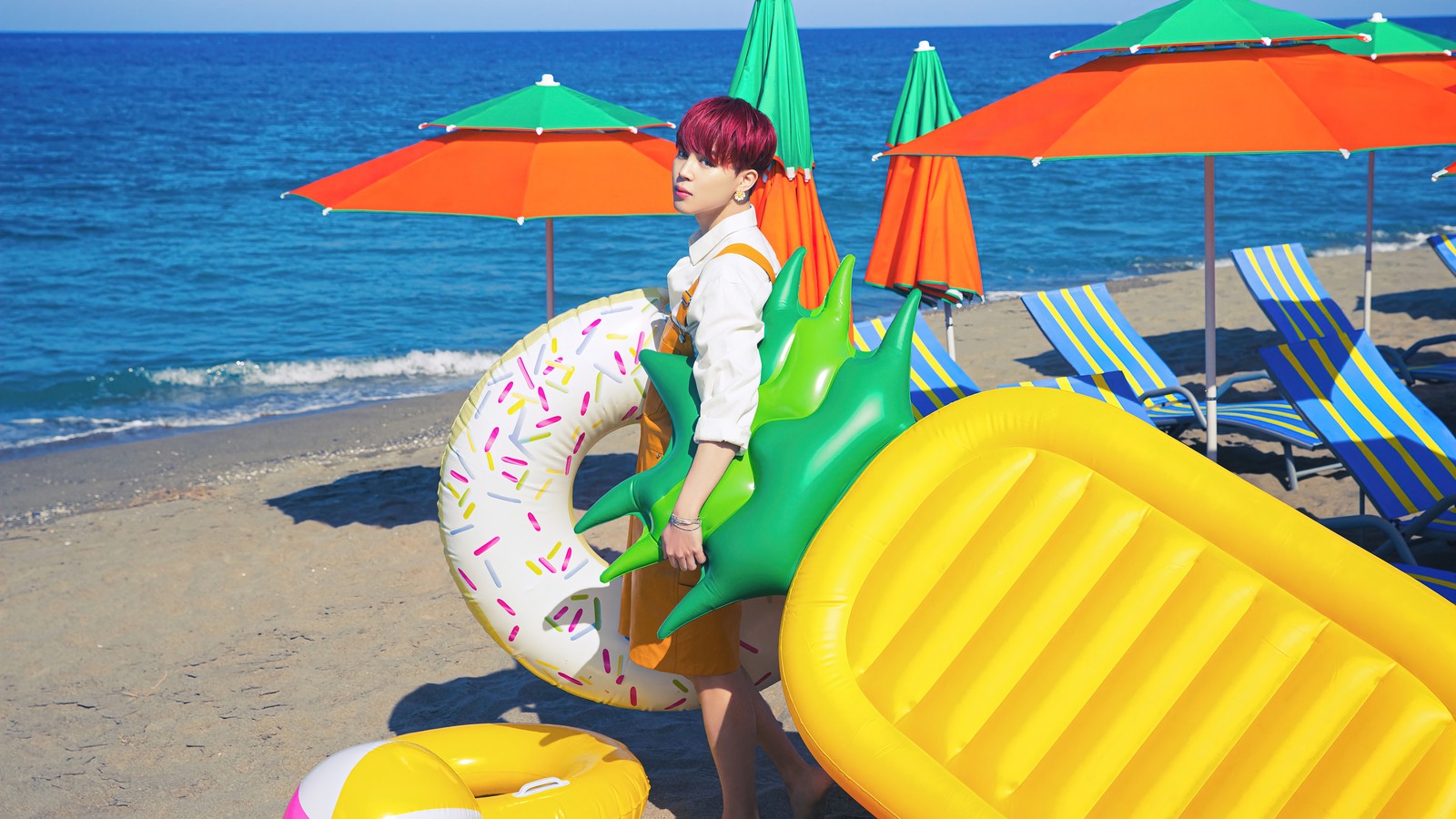 There is a woman standing on the beach with a life preserver (bts, 방탄소년단, k pop, korean, boy group)