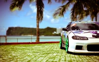 Customized Nissan Silvia: A Blue Performance Sports Car Against a Scenic Coastal Background