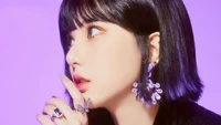 Eunha of VIVIZ, adorned with stunning jewelry, poses against a vibrant purple background, exuding elegance and charm.