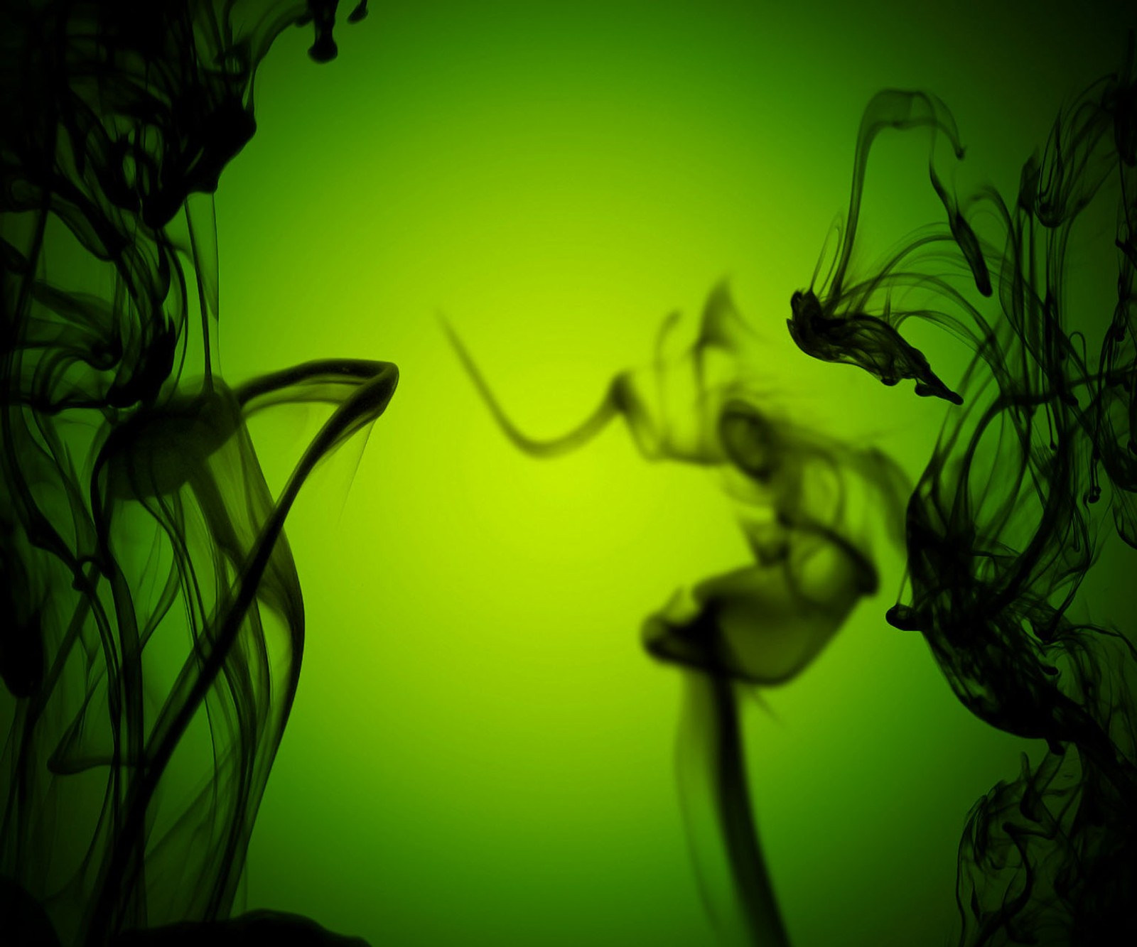 A close up of a green background with smoke in the air (abstract, black smoke)