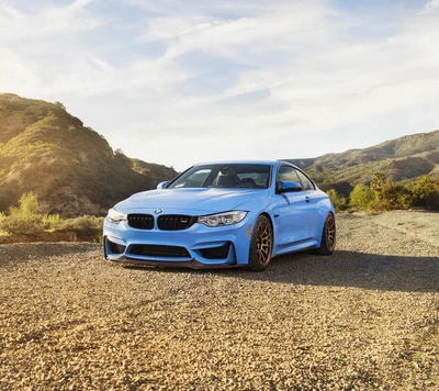 Stunning BMW M4 F82 Coupe in Vibrant Blue, Set Against a Scenic Mountain Backdrop