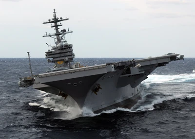 United States Navy Aircraft Carrier Navigating Rough Seas