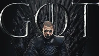 Grey Worm sentado no Trono de Ferro, personificando força e liderança de "Game of Thrones".