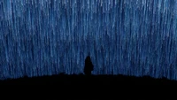 Silhouette of a Girl Beneath Falling Stars in a Night Sky