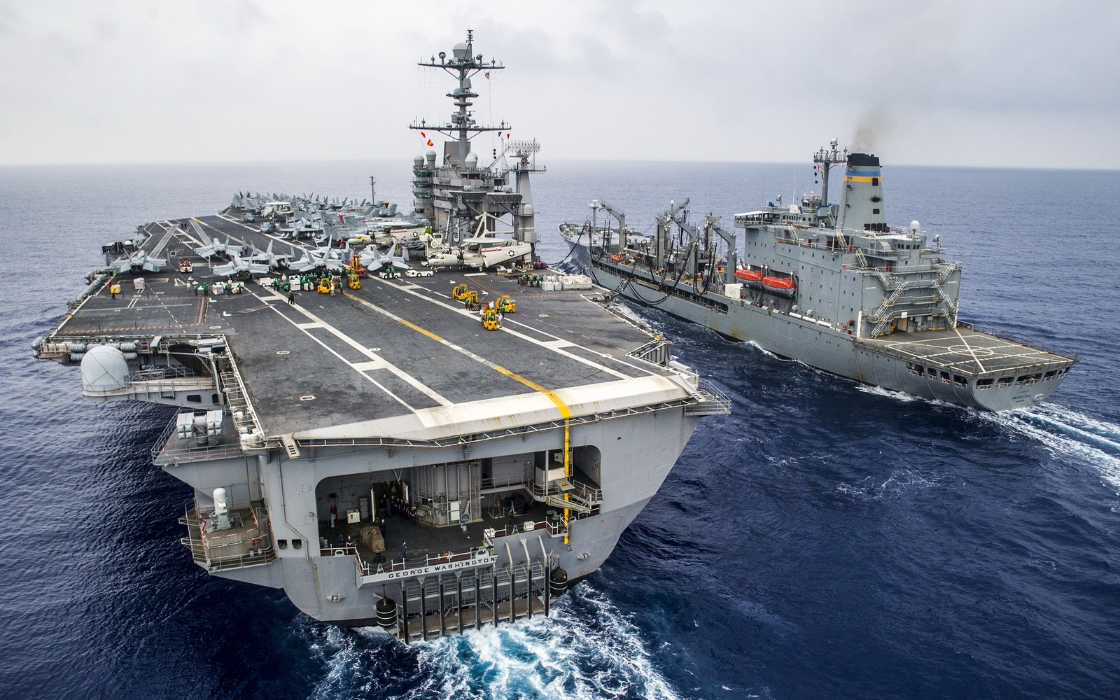 A close up of two ships in the water near one another (uss ronald reagan, aircraft carrier, united states navy, warship, ship)