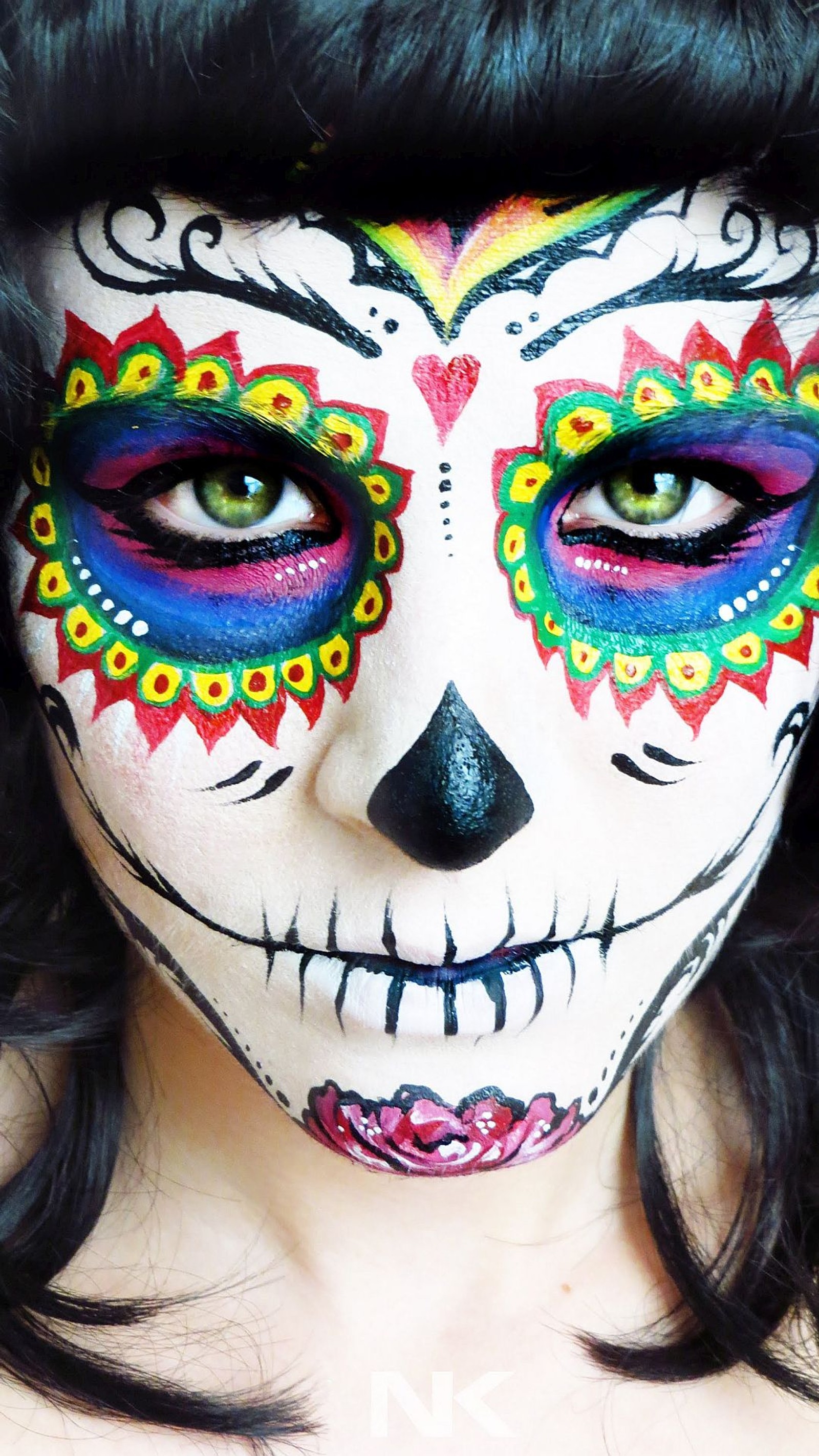 A close up of a woman with a colorful face paint (day of the dead, face)