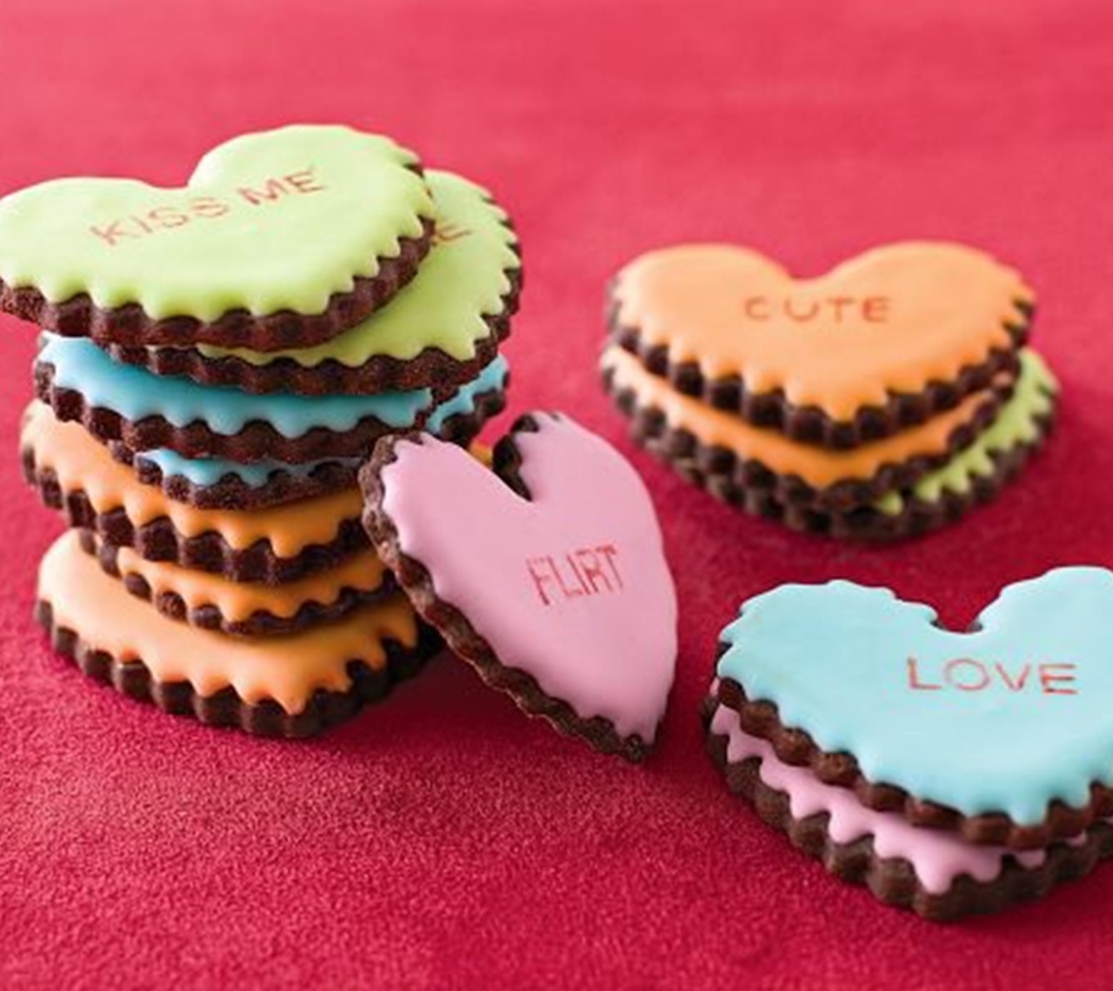 A close up of a stack of cookies with conversation hearts on them (cookies, love)