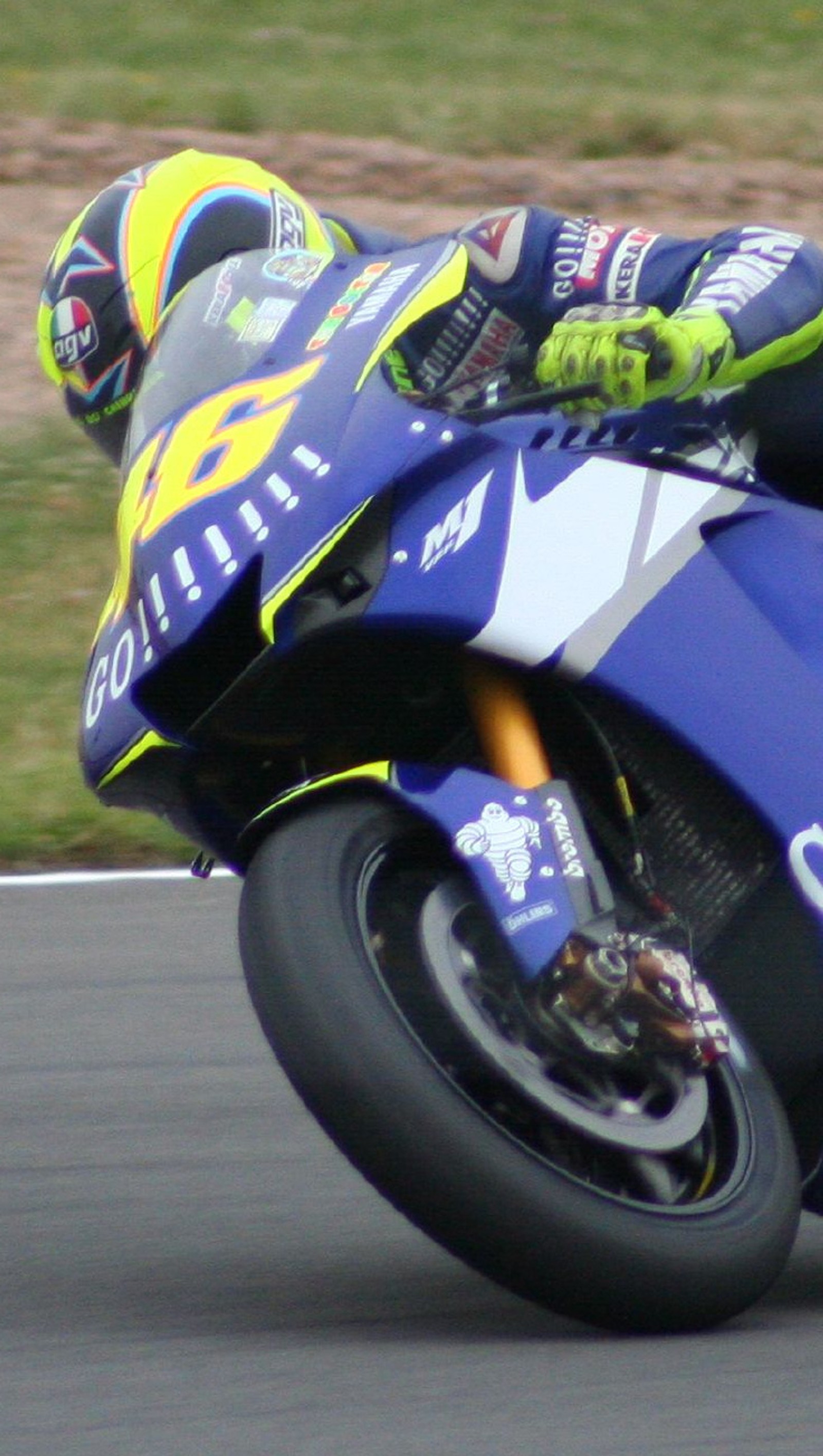 Arafed motorcycle racer leaning on the back of a blue motorcycle (46, rossi)