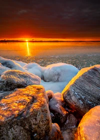 Golden Sunrise Over Icy Shoreline