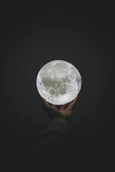 Handheld Lunar Sphere: A Still Life Art Representation