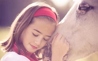 Blissful Bond: Girl Embracing a Horse in Soft Pink Tones