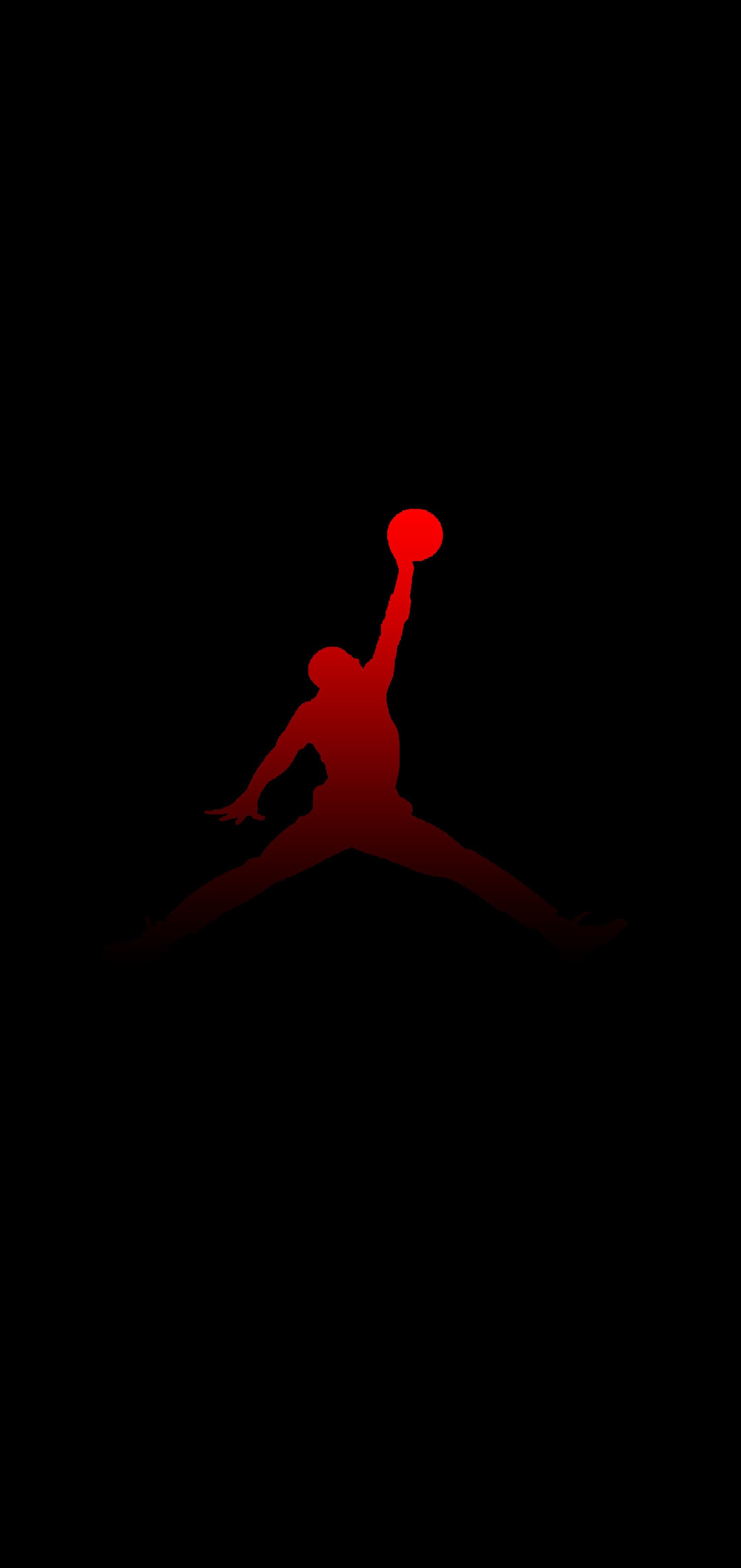 There is a silhouette of a man holding a frisbee in the dark (jordan, micheal, michealjordan, nike, red)