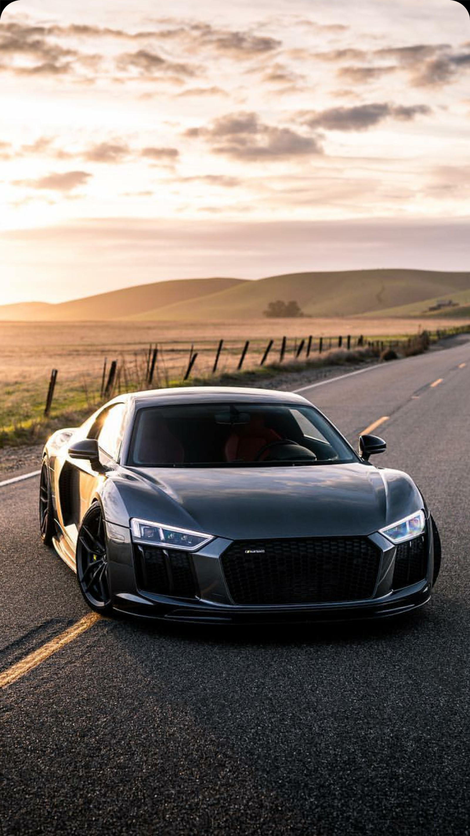 A close up of a car on a road with a fence in the background (audi, r8, car, supercar, wallpaper)